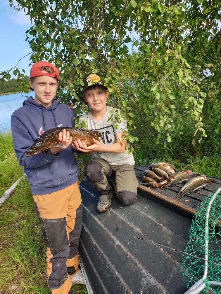 Nathan och kusinen William i båten med dagens fångst — en gädda och en rad abborrar